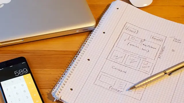 person writing coding in the book